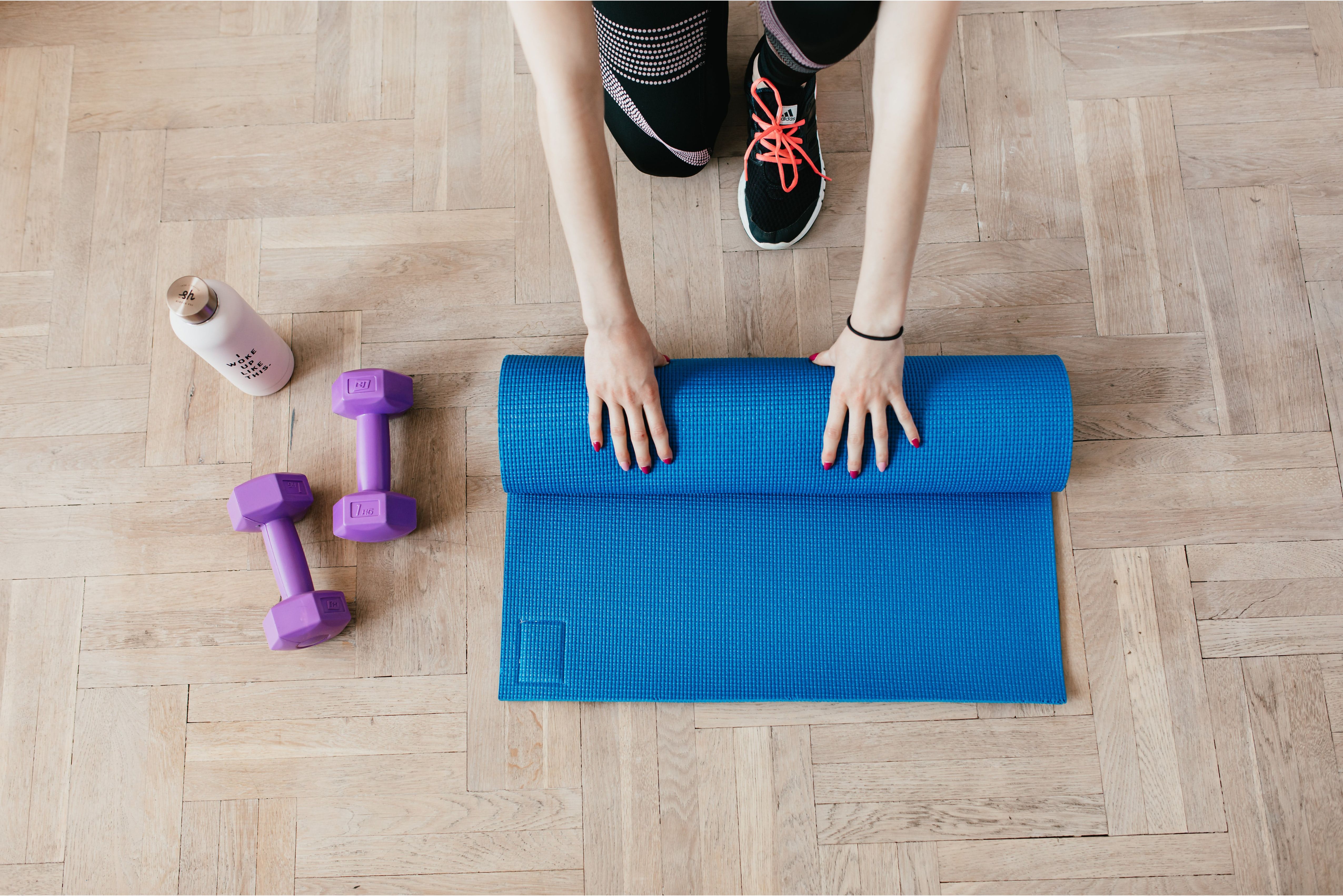 A person rolling up a yoga mat